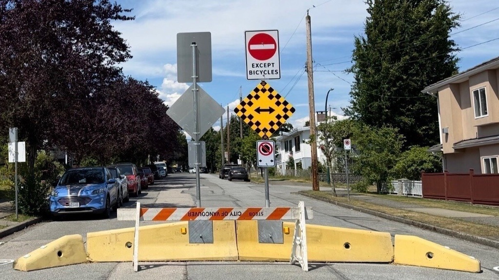 A street barricade in East Vancouver signed for bicycle access only